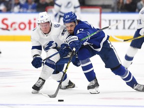 Tampa Bay Lightning's Ondrej Palat (left) pursues the puck with Maple Leafs' Timothy Liljegren during the second period at Scotiabank Arena on Thursday, Dec. 9, 2021.