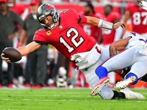 Tom Brady of the Tampa Bay Buccaneers stretches for a first down against the Buffalo Bills at Raymond James Stadium on December 12, 2021 in Tampa, Florida.