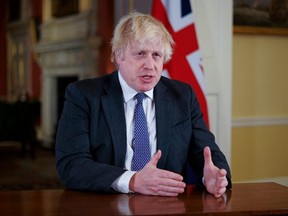 British Prime Minister Boris Johnson gestures as he records an address to the nation, to provide an update on the booster COVID-19 vaccine program at Downing Street, in London, Sunday, Dec. 12, 2021.