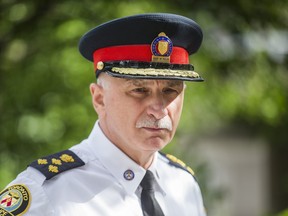 Toronto Police Chief James Ramer is joined by Toronto Police Association President Jon Reid (not pictured) and Mayor John Tory, outside Toronto City Hall on Friday, July 2 2021.