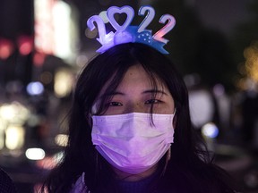A woman wears a 2022 light up headband to celebrate the new year on December 31, 2021 in Wuhan, Hubei Province, China.