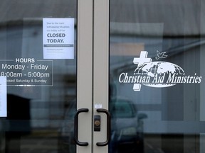 Signs on the door of the Christian Aid Ministries give updates on the Haiti kidnapping and show the the offices are closed in Millersburg, Ohio, Oct. 21, 2021.