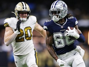 CeeDee Lamb of the Dallas Cowboys carries the ball as Pete Werner of the New Orleans Saints chases at Caesars Superdome on December 2, 2021 in New Orleans.