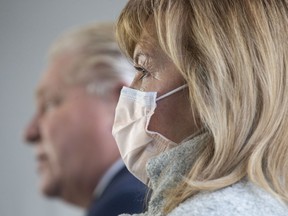 Ontario Health Minister Christine Elliott stands alongside Premier Doug Ford as he takes a question from the media following an announcement at Mississauga Hospital in Mississauga on Wednesday, December 1, 2021.