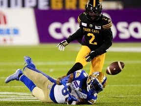 Winnipeg Blue Bombers wide receiver Rasheed Bailey makes a catch as Hamilton Tiger-Cats defensive back Tunde Adeleke looks on during the 108th CFL Grey Cup in Hamilton, Ont., on Sunday, Dec. 12, 2021.