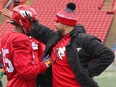 Defensive Line coach Corey Mace (R) gives instructions to Rickey Neal during the first day of Calgary Stampeders' rookie camp in Calgary Thursday, May 16, 2019.