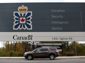 A vehicle passes a sign outside the Canadian Security Intelligence Service (CSIS) headquarters in Ottawa, November 5, 2014.