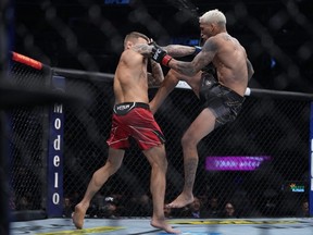 Charles Oliveira, right, moves in with a hit against Dustin Poirier during UFC 269 at T-Mobile Arena in Las Vegas, Saturday, Dec. 11, 2021.