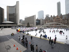 People skate in Nathan Phillips Square outside Toronto City Hall on December 23, 2021.