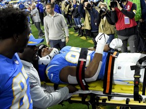 Donald Parham of the Los Angeles Chargers is taken off the field to be assessed further for injury in the first quarter of the game against the Kansas City Chiefs at SoFi Stadium on Dec. 16, 2021 in Inglewood, Calif.
