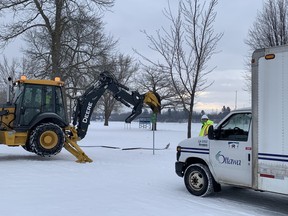 City of Ottawa crews at Mooney’s Bay rip out metal posts at the bottom of the hill where a child died sledding Monday, Dec. 27, 2021.