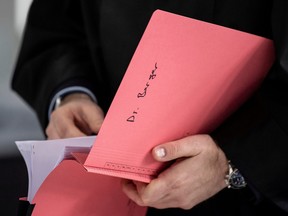 A lawyer of the main defendant Hanno Berger reads in his files before the start of the so-called "Cum-Ex" share deals trial in Wiesbaden, Germany, March 25, 2021.