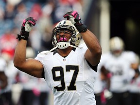 Defensive end Glenn Foster of the New Orleans Saints takes the field before the start of the Saints and New England Patriots game at Gillette Stadium on Oct. 13, 2013 in Foxboro, Mass.