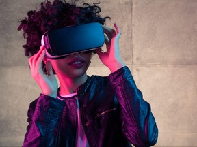 Pretty young woman adjusting a VR headset.