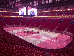 The Philadelphia Flyers and Montreal Canadiens stand during the anthems in an empty arena after the Quebec Government requested that tonight's game be played without spectators at Centre Bell on December 16, 2021 in Montreal.