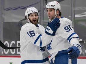 Toronto Maple Leafs forward Alexander Kerfoot (15) and forward John Tavares (91) celebrate Tavares’ goal against the Vancouver Canucks on March 6, 2021 at Rogers Arena.