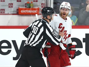 Carolina Hurricanes defenceman Ian Cole objects after he was ejected for a kneeing major against Winnipeg Jets centre Mark Scheifele in Winnipeg on Tues., Dec. 7, 2021.