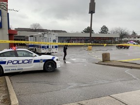 Peel Regional Police at the scene Dec. 6, 2021, the day after a double shooting in a plaza in the Central Park Dr. -Graham Cres. area of Brampton sent a man and a woman to hospital.