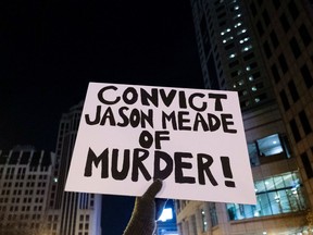 A placard reading "Convict Jason Meade of Murder" is pictured as people protest in reaction to the death of Casey Goodson, a 23-year-old Black man who was killed by police as he entered his home, in Columbus, Ohio, December 11, 2020.