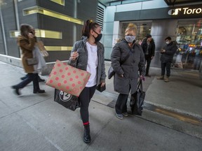 Jessica Malandrino (left) and her mother Mary Malandrino leave CF Toronto Eaton Centre after a shopping trip in Toronto, Ont. on Saturday, Dec. 4, 2021.