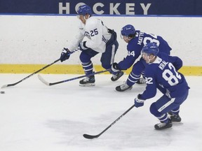 Toronto Maple Leafs’ Ondrej Kase skates away from  Auston Matthews (centre) and Filip Kral during practice this week.  
Jack Boland/Toronto Sun