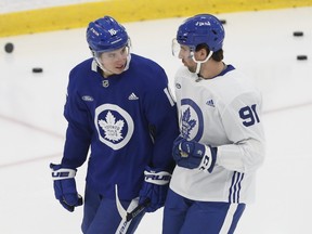 Toronto Maple Leafs John Tavares C (91) and teammate Mitch Marner (16) chat on the ice before drills. Sixteen players were at their first practice after the Western road trip that saw COVID numbers soar  in Toronto.
