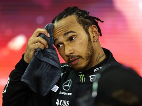 Second placed and championship runner up Lewis Hamilton of Great Britain and Mercedes GP looks dejected in parc ferme  during the F1 Grand Prix of Abu Dhabi at Yas Marina Circuit on Dec. 12, 2021 in Abu Dhabi, United Arab Emirates.