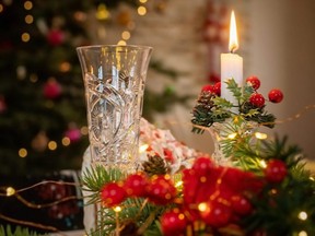 Colorful composition with candle and wineglass on a Christmas table