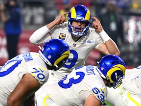 Matthew Stafford of the Los Angeles Rams calls a play at the line of scrimmage in the second quarter of the game against the Arizona Cardinals at State Farm Stadium on Dec. 13, 2021 in Glendale, Ariz.