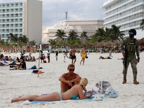 A member of the Navy patrols a beach resort as part of the vacation security in the tourist zone in Cancun by the government of Quintana Roo, Mexico December 5, 2021.