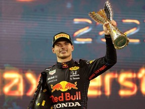 Race winner and 2021 F1 World Drivers Champion Max Verstappen celebrates on the podium during the F1 Grand Prix of Abu Dhabi at Yas Marina Circuit in Abu Dhabi, United Arab Emirates, Sunday, Dec. 12, 2021.