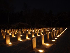 In this file photo from 2014, candles illuminate the graves in the Holten Canadian War Cemetery in The Netherlands.