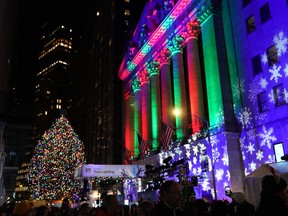 The facade of the New York Stock Exchange is lit up in Christmas colors during the 98th Annual Christmas Tree Lighting Ceremony at the New York Stock Exchange on December 1, 2021 in New York.