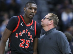Toronto Raptors forward Chris Boucher (left) and head coach Nick Nurse speak during a game early this month.