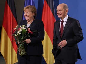 New German Chancellor Olaf Scholz (right) and former German Chancellor Angela Merkel pose for a photo during the official transfer of office at the Chancellery on December 8, 2021 in Berlin.