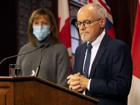 Ontario Chief Medical Officer Dr. Kieran Moore, right, and Health Minister Christine Elliott attend a press briefing at Queen's Park in Toronto, Friday, Dec. 10, 2021.