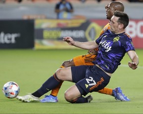 New Toronto FC center-back Shane O'Neill slips to make a tackle. The Canadian press