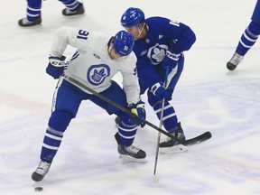 Toronto Maple Leafs John Tavares (left) tries to get around teammate Mitch Marner (right) during a three-on-three drill. Sixteen players were at their first practice after the Western road trip that saw COVID numbers soar  in Toronto.