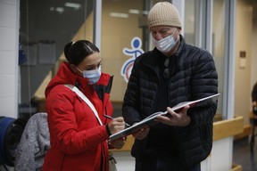 Marissa Papaconstantinou, who has been running since she was 12, is seen here with Mike Strobel on Wednesday, Dec. 8, 2021. The Paralympian track star competed in Tokyo last year and won a Bronze Medal in the T64 100m event.