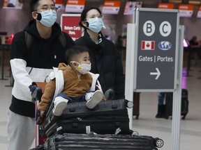Travellers are pictured at Pearson International Airport on Dec. 15, 2021.