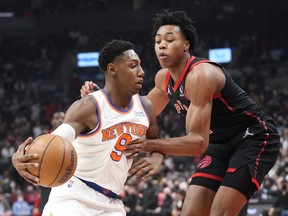 RJ Barrett of the New York Knicks drives against Scottie Barnes of the Toronto Raptors during the first half of their basketball game at the Scotiabank Arena on December 10, 2021 in Toronto.