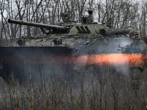 A Russian service member fires near a BMP-3 infantry fighting vehicle during tactical combat exercises held by a motorised rifle division at the Kadamovsky range in the Rostov region, Russia Dec. 10, 2021.