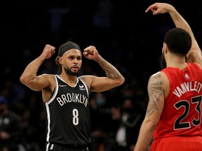 Brooklyn Nets guard Patty Mills (8) and Toronto Raptors guard Fred VanVleet (23) react during overtime at Barclays Center.