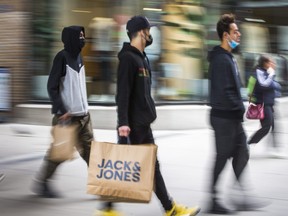 Shoppers along Queen St. W., near Yonge St. in downtown Toronto, Ont. on Oct. 17, 2021.