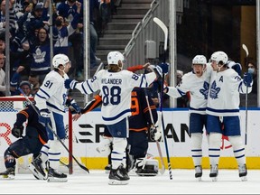 The celebration begins, both on and off the ice, after Maple Leafs forward Auston Matthews (right) opened the scoring with a first-period goal in Edmonton on Dec. 14, 2021.