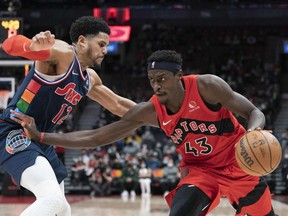 Toronto Raptors forward Pascal Siakam (right) controls the ball as Philadelphia 76ers forward Tobias Harris tries to defend during the fourth quarter of an NBA game on Dec. 28, 2021, at Scotiabank Arena in Toronto.