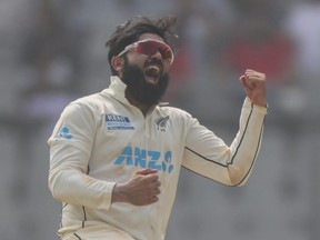 New Zealand's Ajaz Patel celebrates the taking of a wicket during a Test match against India.