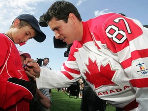 Sidney Crosby signs autographs as he enters the stadium during the Hockey Heroes celebration at Commonwealth Stadium in Edmonton on June 28, 2010.
