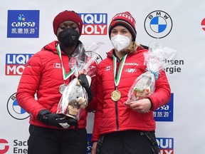 Women’s Monobob gold medallist, Canada's Christine de Bruin (right), celebrates on the podium with silver medallist, Canada's Cynthia Appiah, on Dec. 18, 2021 in  Altenberg, Germany.