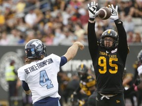 Toronto Argonauts quarterback McLeod Bethel-Thompson deals with defensive end Julian Howsare of the Hamilton Tiger Cats during a CFL game in Hamilton on Oct. 11, 2021. 



Jack Boland/Toronto Sun/Postmedia Network
